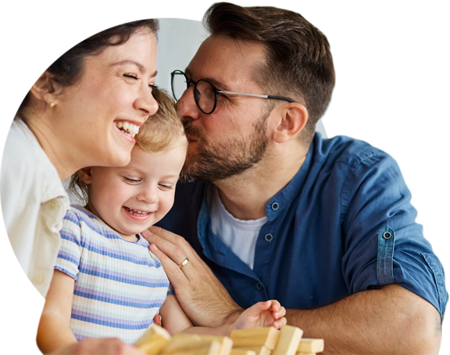 Smiling family — a mother and father with their young child seated together, the father giving a gentle kiss while they all laugh, inside a circular graphic representing NVB Swipe To Save.